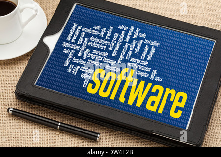 computer software word cloud on zero one binary background - digital tablet with a cup of coffee Stock Photo