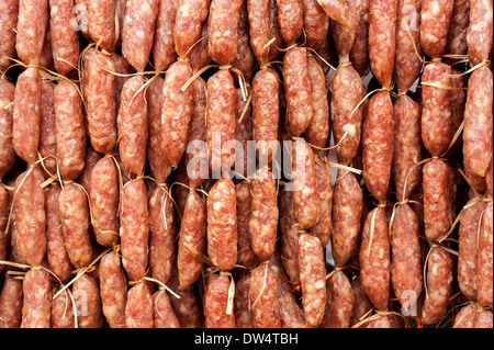 Hand made smoked sausages for sale hanging at asian food market Stock Photo