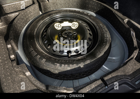 Space-saver spare wheel in trunk of car with limited speed limit of maximum 50 mph / 80 km/h Stock Photo