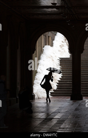 Manhattan New York city in North America, Pictured Grand Central Park a dancer poses with umbrella in Bethesda Arcade Stock Photo