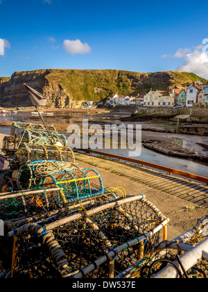 Stacked crab and lobster pots in the harbour of Staithes. North Yorkshire, UK. Stock Photo