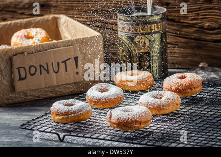 Falling icing sugar on fresh donuts Stock Photo