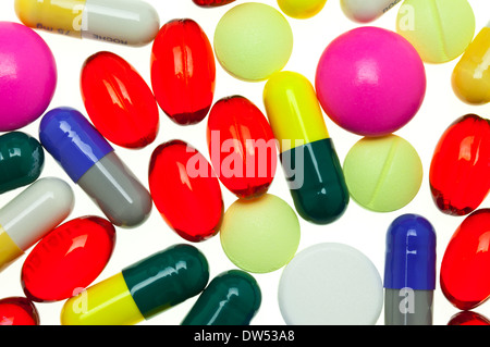 lots of multi-coloured assorted medicines TABLETS CAPSULES drugs pills on a white background pill, tablet, capsule, drug Stock Photo