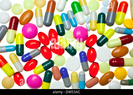 lots of multi-coloured assorted medicines drugs pills on a white background tablet tablets capsule capsules drug drugs pill pills