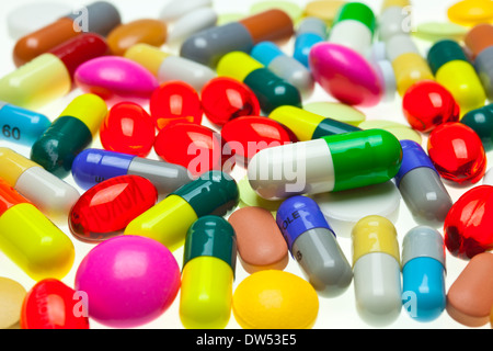 multi-coloured assorted medicines drugs pills and tablets on a white background Stock Photo