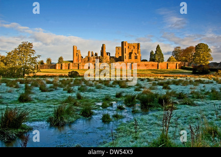 The ruins of Kenilworth Castle in Warwickshire on a frosty winter morning seen across the field that was once the castle moat. Stock Photo