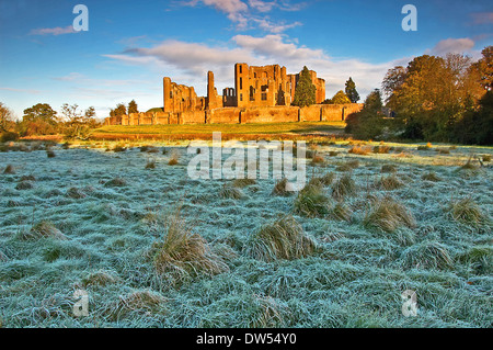 The ruins of Kenilworth Castle in Warwickshire on a frosty winter morning seen across the field that was once the castle moat. Stock Photo