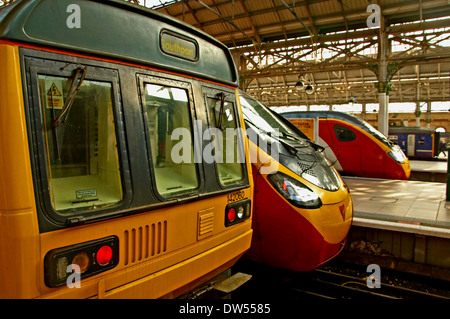 Passenger trains waiting in a station platforms at Manchester Piccadilly station. Stock Photo