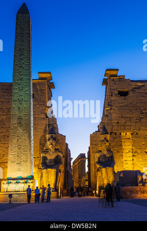 The obelisk and statues of Ramesses II at the entrance to Luxor Temple. Stock Photo