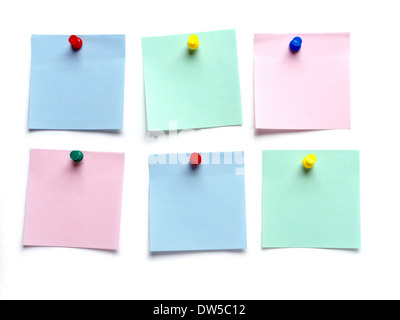 Six blank adhesive notes pinned on white surface Stock Photo
