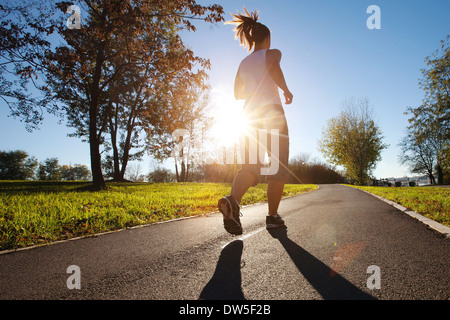 Young woman running in the park Stock Photo