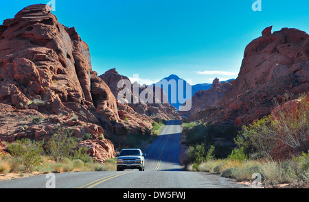 Single Car on Lonely road through Valley of Fire,  Nevada, USA Stock Photo