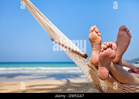 couple in hammock on the beach Stock Photo