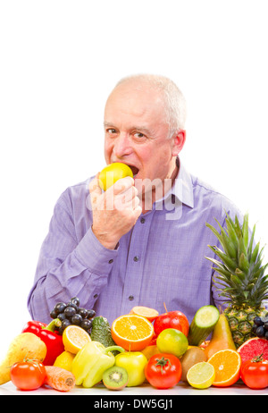 Closeup of senior man eating a green apple against white background Stock Photo