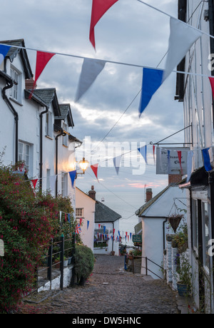 Bunting above the cobbled streets of Clovelly at dawn, North Devon, England. Summer (August) 2012. Stock Photo