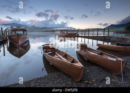 Boats moored on Derwent Water at dawn, Keswick, Lake District, Cumbria, England. Autumn (October) 2012. Stock Photo