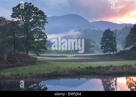 Atmospheric sunset from the River Brathay near Elterwater, Lake District, Cumbria, England. Autumn (October) 2013. Stock Photo