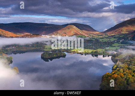 Mist burns off Lake Grasmere in the early morning, Lake District, Cumbria, England. Autumn (October) 2012. Stock Photo