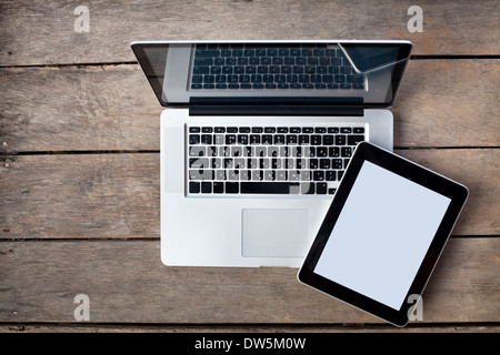 laptop and tablet on old wooden desk Stock Photo