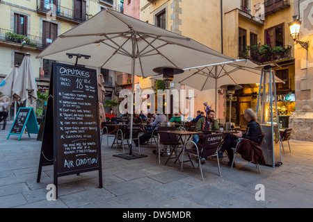 Outdoor cafe with tourists seated at tables in Born neighborhood, Barcelona, Catalonia, Spain Stock Photo
