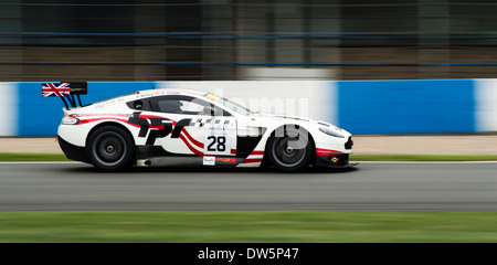 Horsepower Racing and Aston Martin Racing's GT3 car driving full speed around Donington Park Circuit. Stock Photo