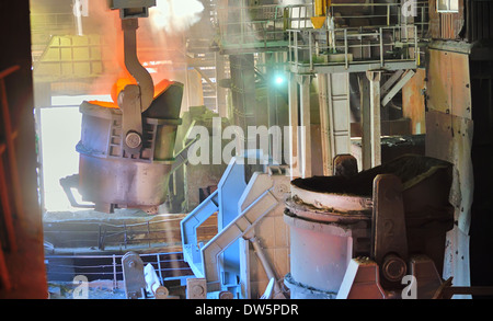 molten metal poured from ladle in factory Stock Photo