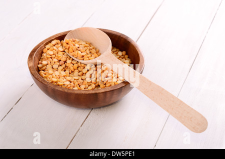 Split dried yellow peas in wooden bowl Stock Photo