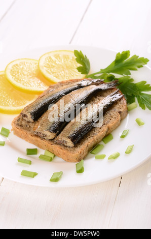 Sprats sandwiches on white plate Stock Photo