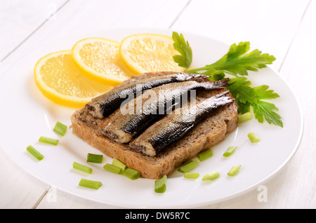 Sprats sandwiches on white plate Stock Photo