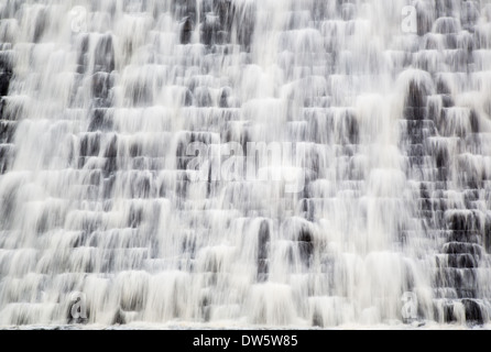 Water cascading down the dam wall at Derwent reservoir after months of heavy rain in the Derbyshire Peak District Stock Photo