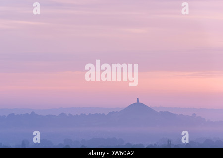 Glastonbury Tor rising surrounded by mist at dawn, Somerset, England. Summer (August) 2013.
