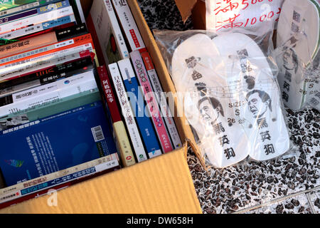 Taipei, Taiwan- February 28, 2014: Slippers printed with MYJ's face were sold on the Liberty Square, formally part of tyrant Chiang Kai-Shek's memorial. On top of them wrote 'trample on the Doggy Ma', a nickname that sounded similar to the president's name  during anniversary of the 1947 massacre which thousands were killed by nationalist Kuomintang troops from China, at the Taipei Peace Park on February 28, 2014. The massacre remained taboo for decades under the late nationalist KMT leader Chiang Kai-shek's rule. Stock Photo