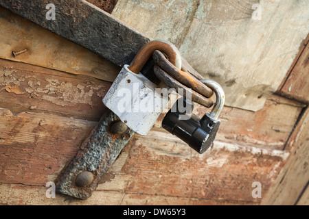 Old locks hanging on wooden door Stock Photo
