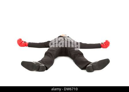 businessman was punched with boxing gloves and lie down on the floor.isolated on white Stock Photo