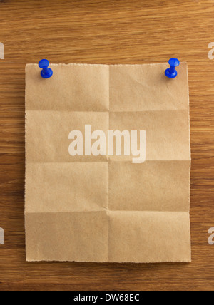 folded note paper on wooden background Stock Photo