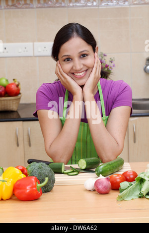 Beautiful young Indian woman in kitchen Stock Photo