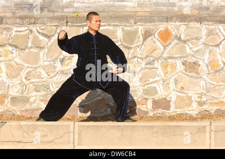 Man exercising kung fu in black outfit. Chengde, China. Stock Photo
