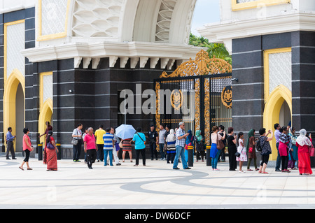 Tourists outside the massive front gate of the Istana Negara, the royal palace of Kuala Lumpur. Stock Photo