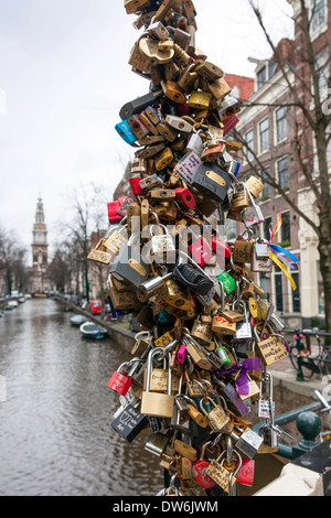 Love padlocks attached to a bridge over a canal, Amsterdam, Netherlands Stock Photo