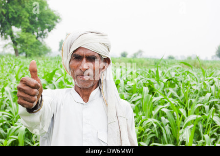 1 Indian farmer standing and showing thumb Stock Photo