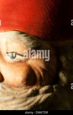 Close up of a ceramic Santa Claus with blue eyes, red hat, and gray beard Stock Photo