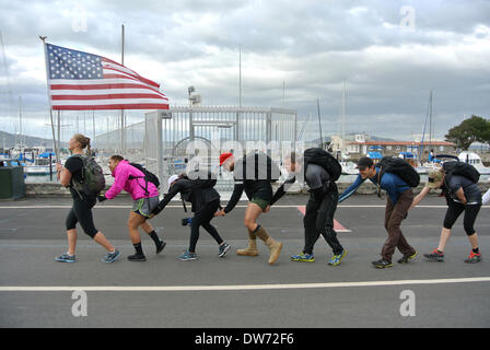 San Francisco, USA. 1st March 2014. Women carryng American flag  leads team of trainees in the Goruck light challenge, a strenuous physical team para military like 10 mile march in the Marina district of San Francisco on Saturday March 1st 2014 Credit:  Bob Kreisel/Alamy Live News Stock Photo