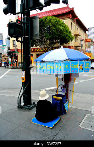 San Francisco, USA. 1st March 2014. Lone religious follower of Falun Dafu Faluin Gong protests on San Francisco street on Saturday March 1st 2014 over the 15 year persecution of Falun Gong followers in China Credit:  Bob Kreisel/Alamy Live News Stock Photo