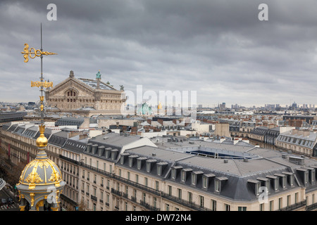 Wind vane and view over the rooftops of Paris from the roof of Printemps department store, Paris, France Stock Photo