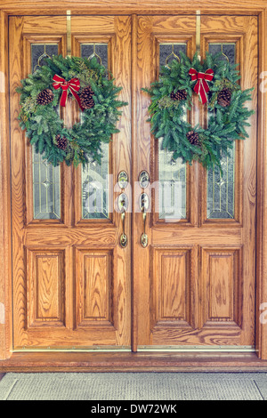 Double Wooden Front Doors With Wreath On Each Stock Photo