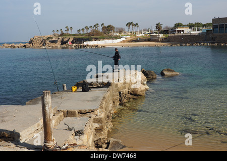 A man fishing in Caesarea Maritima Mediterranean sea Stock Photo