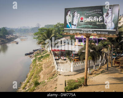 March 2, 2014 - Myawaddy, Kayin, Myanmar - A billboard for Burmese beauty creams in Myawaddy on the Burmese side of the Moie River on the Thai-Burma border. Myawaddy is separated from the Thai border town of Mae Sot by the Moei River. Myawaddy is the most important trading point between Myanmar and Thailand. (Credit Image: © Jack Kurtz/ZUMAPRESS.com) Stock Photo