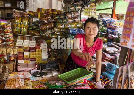 March 2, 2014 - Myawaddy, Kayin, Myanmar - A vendor gives change to a customer in the market in Myawaddy, Myanmar. Myawaddy is separated from the Thai border town of Mae Sot by the Moei River. Myawaddy is the most important trading point between Myanmar (Burma) and Thailand. (Credit Image: © Jack Kurtz/ZUMAPRESS.com) Stock Photo