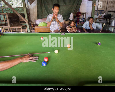 March 2, 2014 - Myawaddy, Kayin, Myanmar - Men play pool in a pool hall in Myawaddy, Myanmar. Myawaddy is separated from the Thai border town of Mae Sot by the Moei River. Myawaddy is the most important trading point between Myanmar (Burma) and Thailand. (Credit Image: © Jack Kurtz/ZUMAPRESS.com) Stock Photo