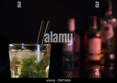 Cocktail on a Bar with bottles Stock Photo